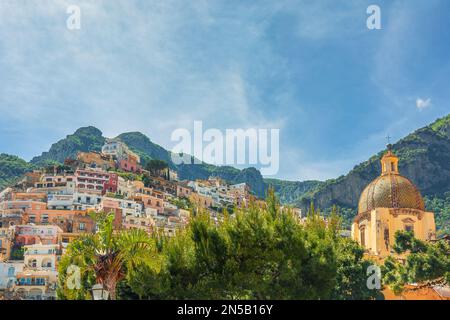 Positano town with colorful buildings and church of Our Lady of the Assumption on Amalfi coast, Campania, Italy. Popular summer resort Stock Photo