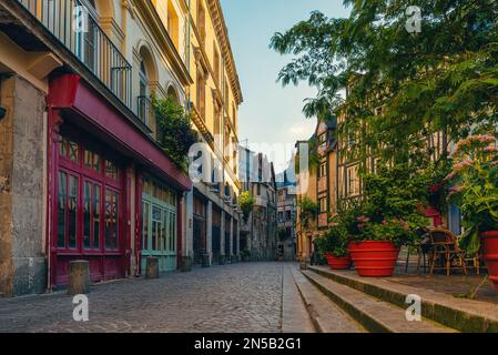 Old cozy empty street with timber framing houses, flower pots and cafe in Rouen, Normandy, France. Popular travel destination Stock Photo