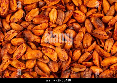 Spicy peanuts snack with hot pepper macro. Nuts with spices appetizer Stock Photo