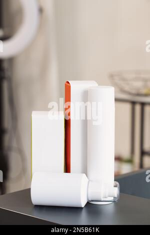 Cosmetic bottle containers on beauty studio salon background, Blank label for branding mock-up, Beauty product concept Stock Photo