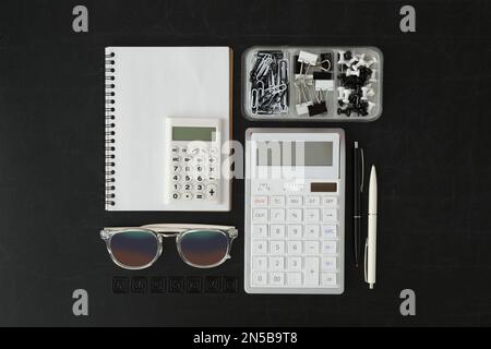 Flat lay composition with different school stationery on blackboard. Back to school Stock Photo