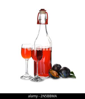 Delicious plum liquor and ripe fruits on white background. Homemade strong alcoholic beverage Stock Photo