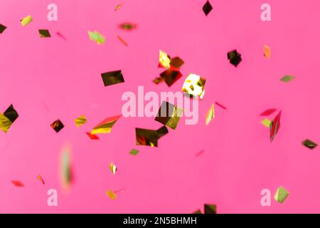 Shiny golden confetti falling down on light blue background Stock Photo ...