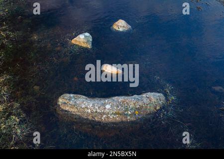 , a natural smiley made of stones in the middle of a puddle, United Kingdom, Scotland, Highlands Stock Photo