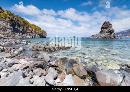 Volcanic bay with a view of the stack and Lipari and Salina in the background, Vulcano Stock Photo