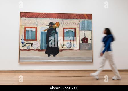 LONDON, UNITED KINGDOM - FEBRUARY 09, 2023: A gallery staff member walks past a painting titled 'Music Shop' (2019-23) by Peter Doig (b. 1959), during a photocall for the major exhibition of new and recent works by Peter Doig at The Courtauld Gallery in London, United Kingdom on February 09, 2023. The Morgan Stanley Exhibition: Peter Doig (10 February - 29 may 2023) will present an exciting new chapter in the career of one of the most celebrated and important painters working today and the first exhibition by a contemporary artist to take place at The Courtauld since it reopened in November 20 Stock Photo