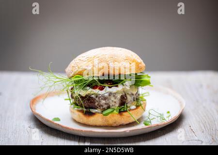 Beef burger with melted cheese in a bun Stock Photo