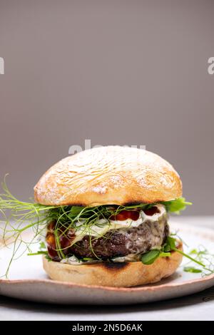 Beef burger with melted cheese in a bun Stock Photo