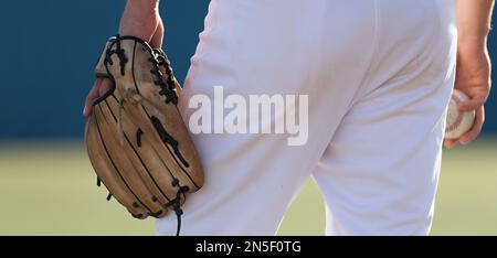 Baseball pitcher ready to pitch in baseball game, college softball player Stock Photo