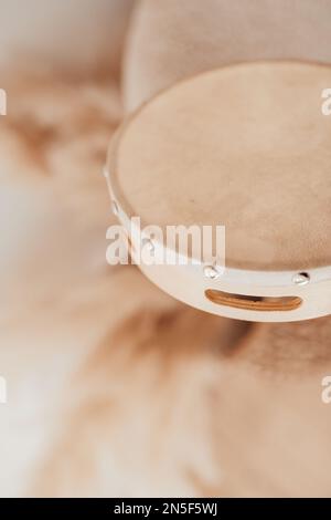 Candid authentic hands of african american man on tambourine being played by ritimist during relax time. Domestic life multi ethnicity male musicant i Stock Photo