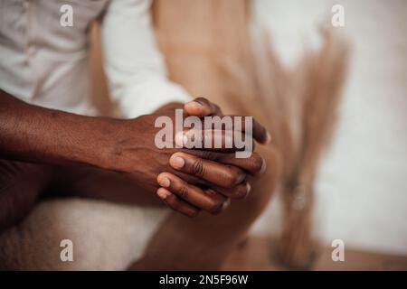 Candid millennial authentic diverse portrait of african american man relax time at apartment in neutrals tones colors interior. Domestic life multi et Stock Photo