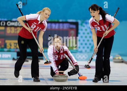 Russia's skip Ekaterina Galkina, center, delivers a stone while her