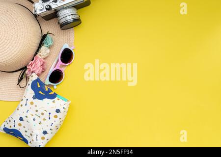 Composition with beach accessories and space for text on yellow background. Summer vacation, holiday, trip and travel concept. Flat lay, banner design Stock Photo