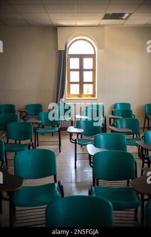 Bethlehem, West Bank, Palestine - 22 July 2022: Bright Window in the Back of a Class Room with Green Chairs Stock Photo