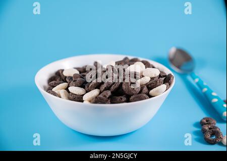 Oreo Flavored Breakfast Cereal, black and white dry breakfast rings. Cup with delicious breakfast and milk. High quality FullHD footage Stock Photo