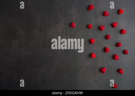 Raspberries on black background. Fresh ripe sweet berries. Selection of healthy food. Slate banner background. top View Stock Photo