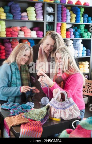 Knitting teacher with two women in knitting lesson, Bavaria, Germany Stock Photo