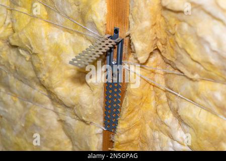 Aluminum frame with hangers placed on beams in the attic for mounting plasterboards. Stock Photo