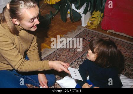 Au Pair Showing Flash Cards To Toddler (austrian Au Pair) Surrey England Stock Photo