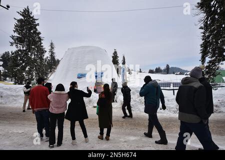 Tourists visit the Igloo cafe and click pictures in Ski resort Gulmarg, Indian Administered Kashmir on 08 February 2023.An igloo cafe, claimed to be the world's largest, has come up at the famous ski-resort of Gulmarg in Jammu and Kashmir. With a height of 112 Meter (40 feet) and a diameter of 12.8 meter (42 feet), creator of the igloo, claimed it was the world's largest cafe of its kind. It took 20 days to complete it with 25 people working day and night, he said, adding that it took 1,700 man-days to complete the project. (Photo by Mubashir Hassan/Pacific Press/Sipa USA) Stock Photo