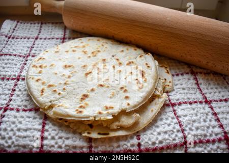 Stack of thin flatbread lavash on a wooden serving board Stock Photo