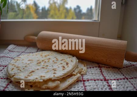 Stack of thin flatbread lavash on a wooden serving board Stock Photo