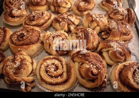 Freshly baked homemade Swedish cinnamon rolls with pearl sugar. Kanelbullar in Swedish. Stock Photo