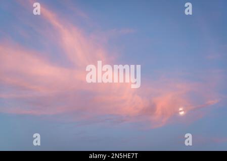 Pink cloudscape with the Moon Stock Photo