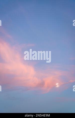 Pink cloudscape with the Moon Stock Photo