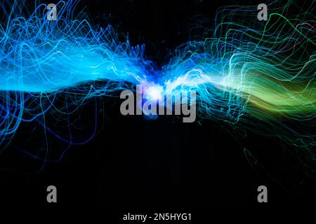 Green and blue light wave of energy with elegant glowing lines. Abstract technology background. Stock Photo