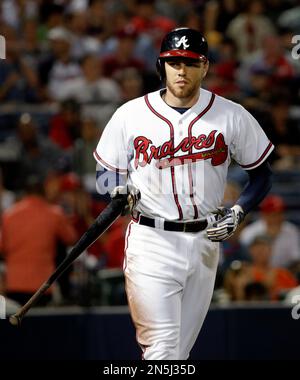 FILE - Atlanta Braves' Freddie Freeman smiles after scoring on a hit by  Marcell Ozuna against the Los Angeles Dodgers during the sixth inning in  Game 4 of a baseball National League