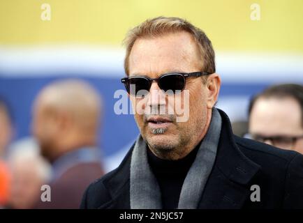 Actor Kevin Costner walks on the field before the NFL Super Bowl