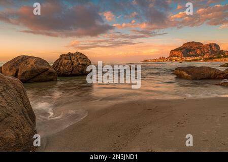 The beach of Cefalù with the town in the background at dusk, Sicily Stock Photo