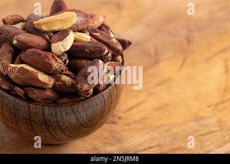 A Bowl of Pili Nuts from the Philippines on a Wooden Table Stock Photo