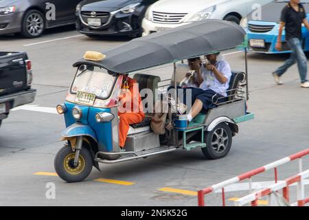 SAMUT PRAKAN, THAILAND, FEB 03 2023, Motor tricycle taxi - Tuk Tuk takes schoolgirls from the market Stock Photo