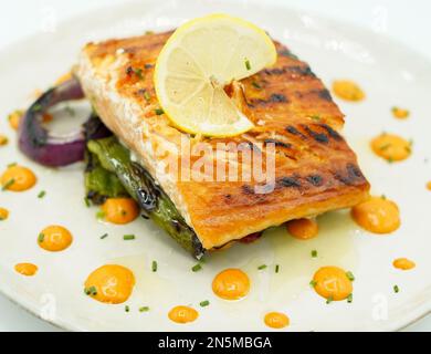 Gourmet grilled Norwegian salmon loin on a mattress of vegetables Stock Photo