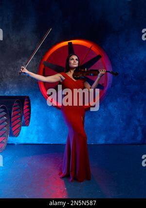 Violin player performing solo over loft interior background Stock Photo