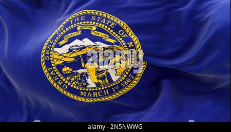 Detail of the Nebraska state flag fluttering. The flag of is blue with the state seal in the center. 3D illustration render. Selective focus. Close-up Stock Photo