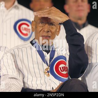 Ernie Banks heavey hitter for the Chicago Cubs, shows his 4- year old twins  the correct way to hold that bat for a home run, February 24, 1964. Taking  advantage of the