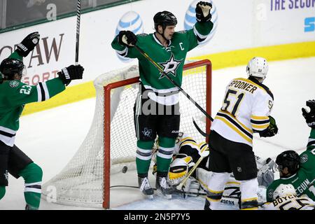 Boston Bruins' Brad Marchand (63) skates over to celebrate a goal with  David Pastrnak, bottom, as Dallas Stars left wing Jamie Benn (14) skates  away from the celebration late in the third