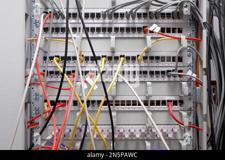 Network technology - multiple colorful cables in an IT and server room Stock Photo