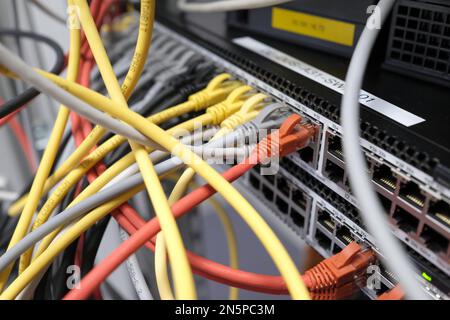 Network technology - multiple colorful cables in an IT and server room Stock Photo