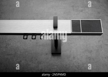 Modern metal eaves of gray color with leather nipples, on a gray concrete wall Stock Photo