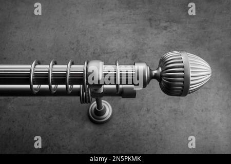 Classic gray metal eaves, with round rings, on a gray concrete wall Stock Photo