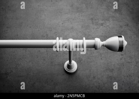Classic white wooden eaves with round rings, on a gray concrete wall Stock Photo