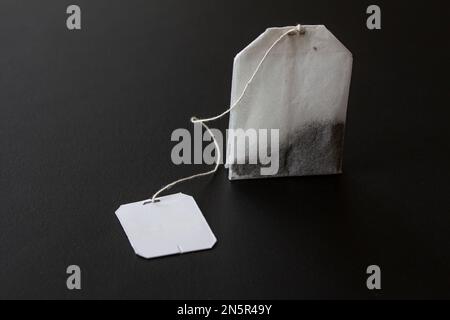 Tea bag on black background. Close up image. Stock Photo