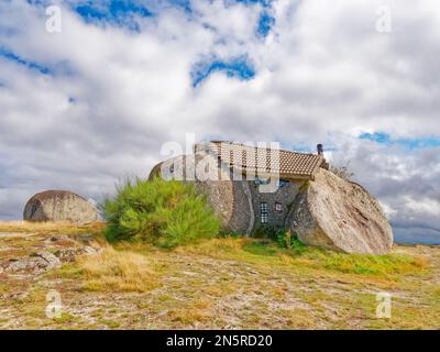 Boulder house or Casa do Penedo, a house built between huge rocks on top of a mountain in Fafe, Portugal. Stock Photo