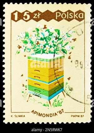 MOSCOW, RUSSIA - FEBRUARY 4, 2023: Postage stamp printed in Poland shows Box hive, orchard, 31st World Apiculture Congress, Warsaw serie, circa 1987 Stock Photo