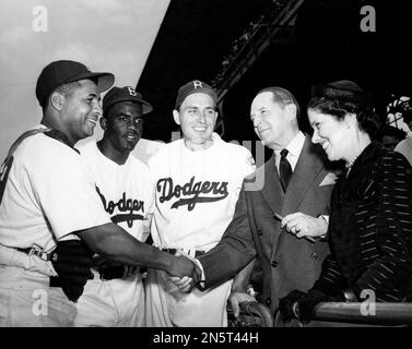 Moose Skowron, right, first baseman of the New York Yankees, jokes with Roy  Campanella about his muscles after the Brooklyn Dodger catcher won the pre- game hitting contest at Ebbets Field, Brooklyn, New