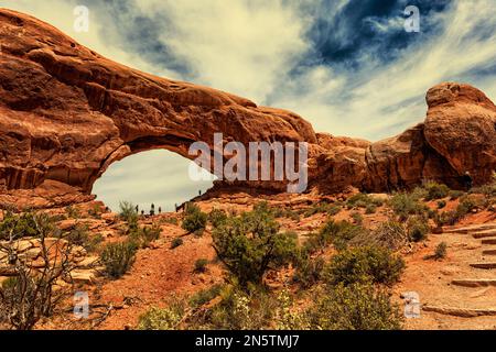 The stone arches with steps going up the rocks side and trees along the path Stock Photo